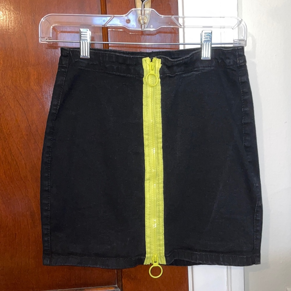 Black jean skirt with highlighter yellow zipper